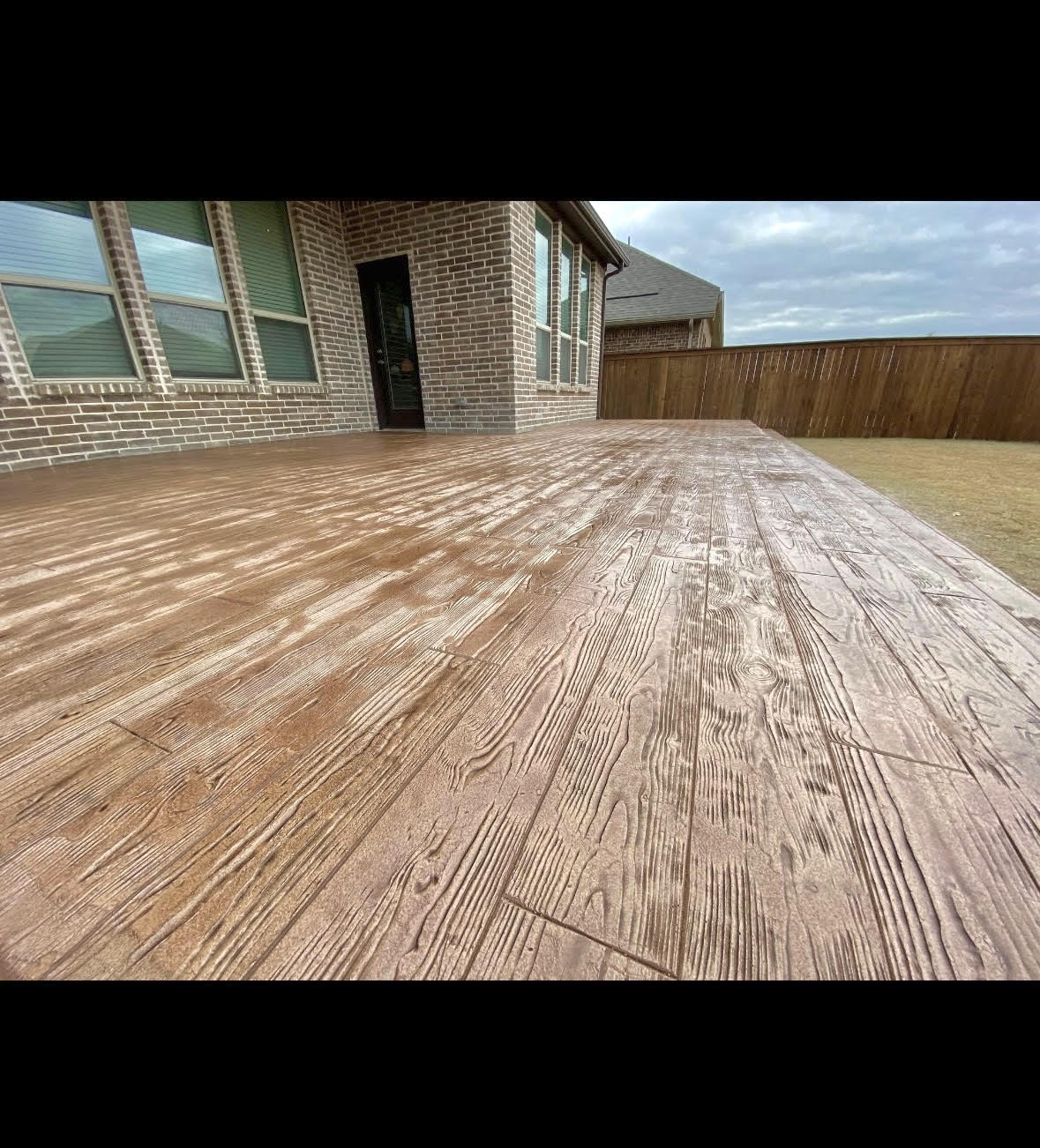 Beautiful wood-texture concrete overlay patio by Carpenter Coating