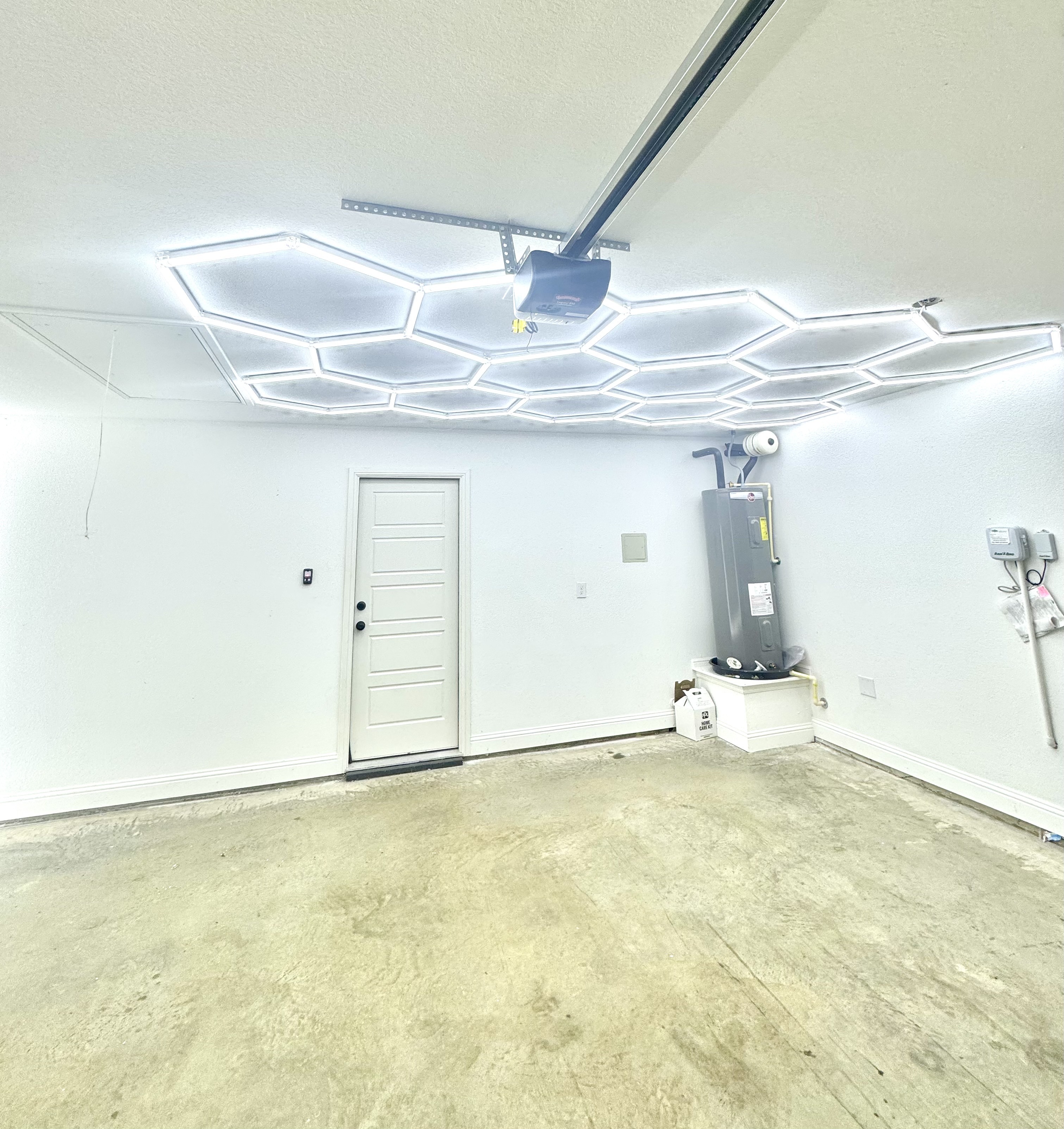 Modern hexagonal LED lights installed in garage ceiling by Carpenter Coating